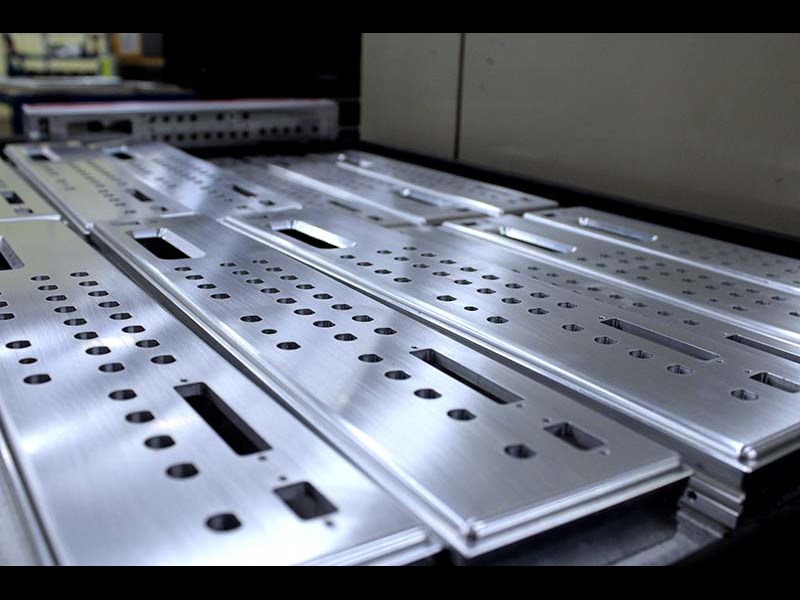 Long pieces of machined material with slits and holes 